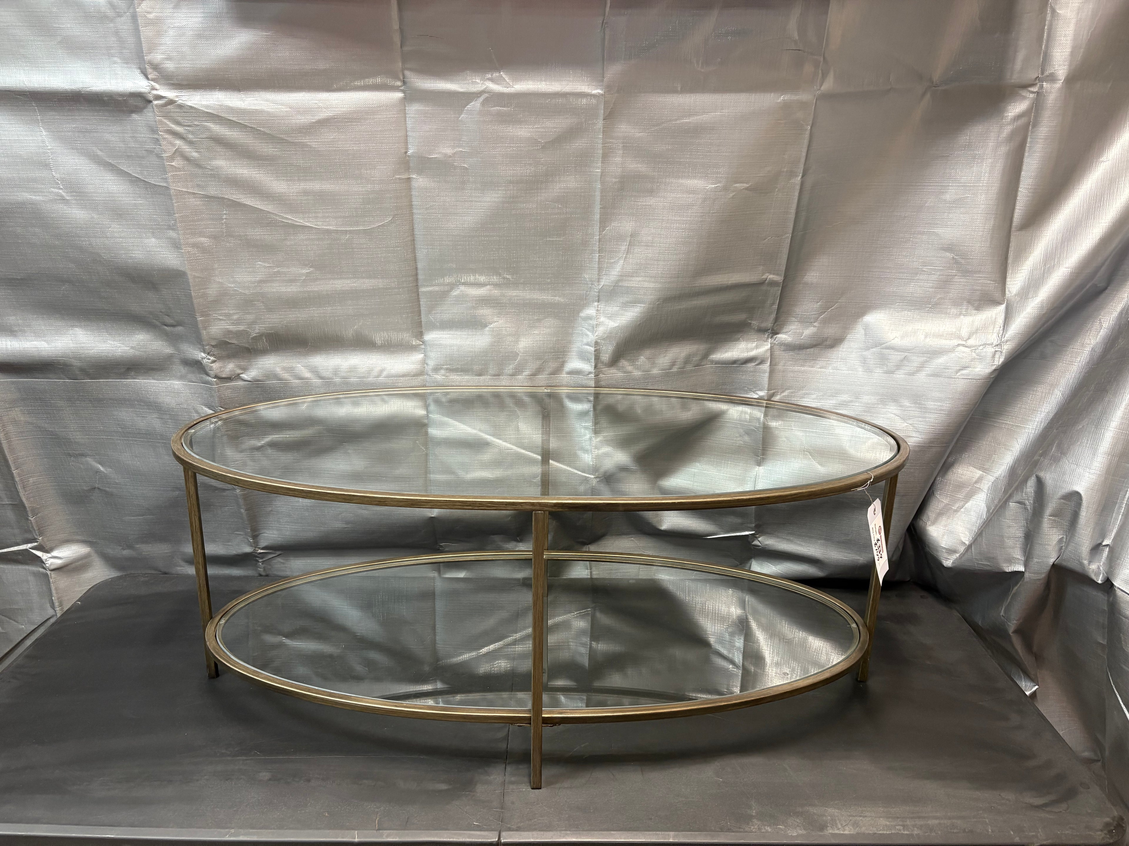 Brand new and fully assembled Home Decorators Collection Bella Large Oval Antique Bronze Metal and Glass Coffee Table with Shelf (46 in. W x 18 in. H)